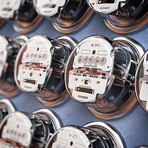 Row of electric meters, measuring power use. 